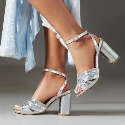 Gold high heel peep toe sandal with an adjustable buckle on the ankle strap.