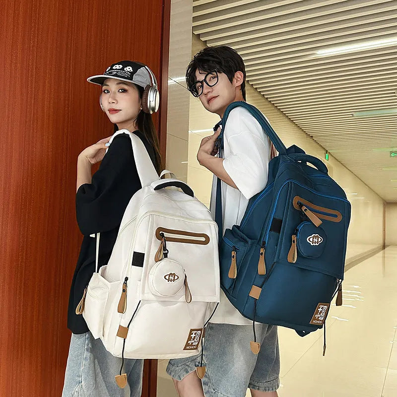 Large waterproof nylon travel backpack in blue with contrast stitching and 20-35 litre capacity