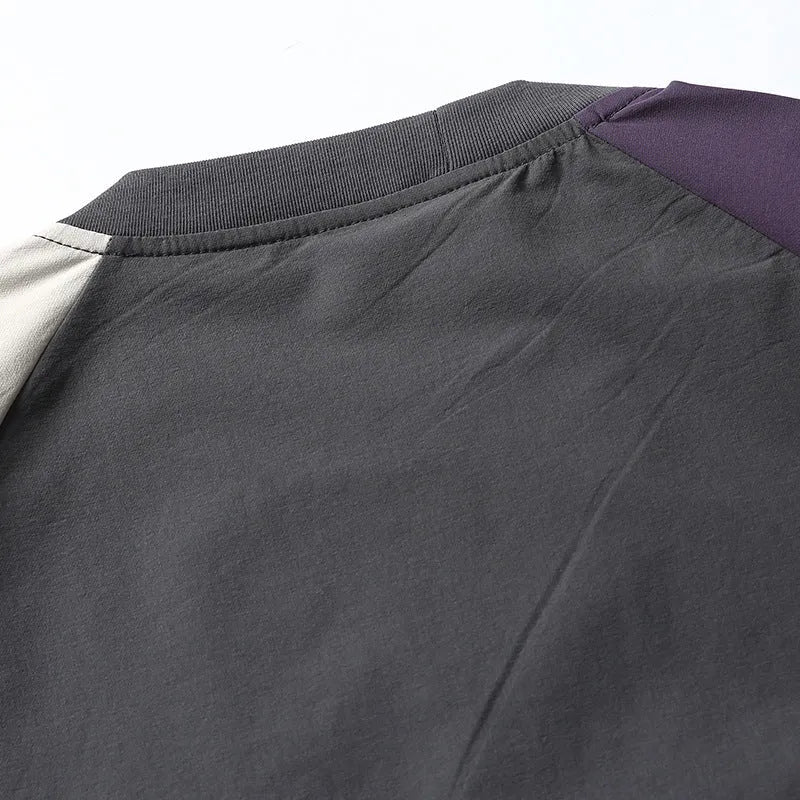 Dark grey loose fit men's t-shirt with contrast colour raglan sleeves on a hanger.