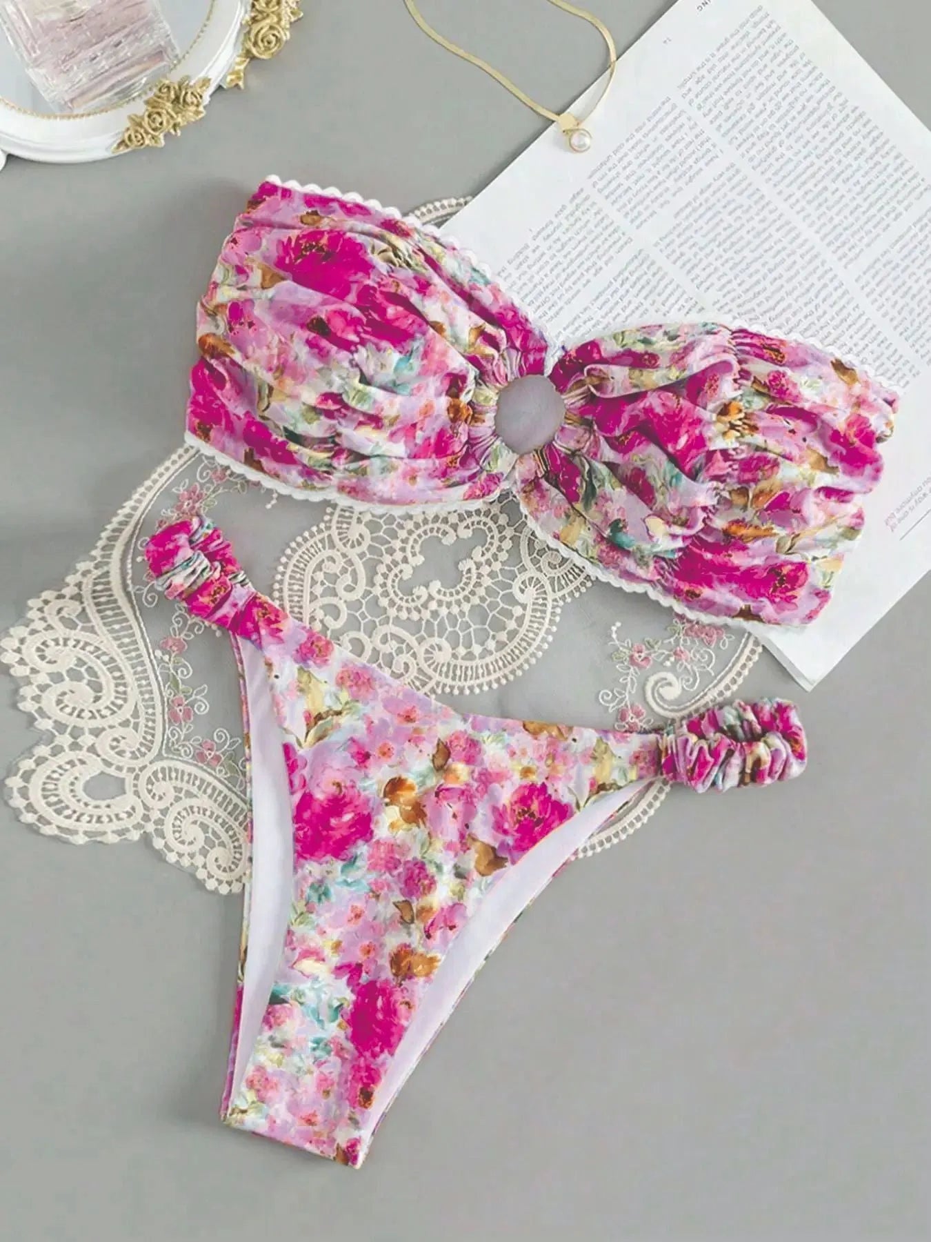 Colourful floral print tube top bikini set with lace trim on a mannequin