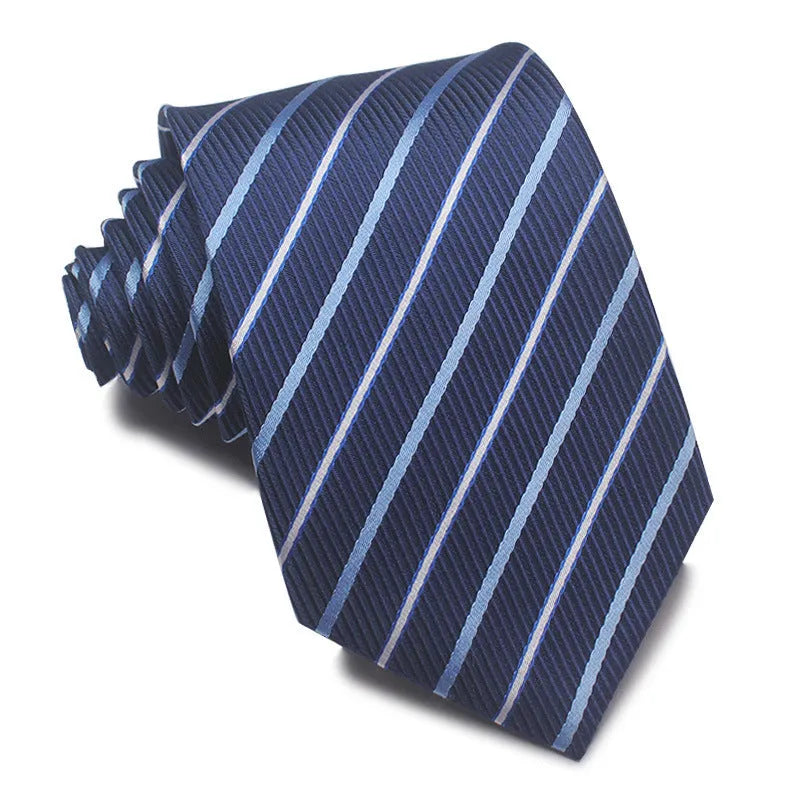 Close-up of a red and black striped jacquard weave tie with an arrow tip, showing texture.