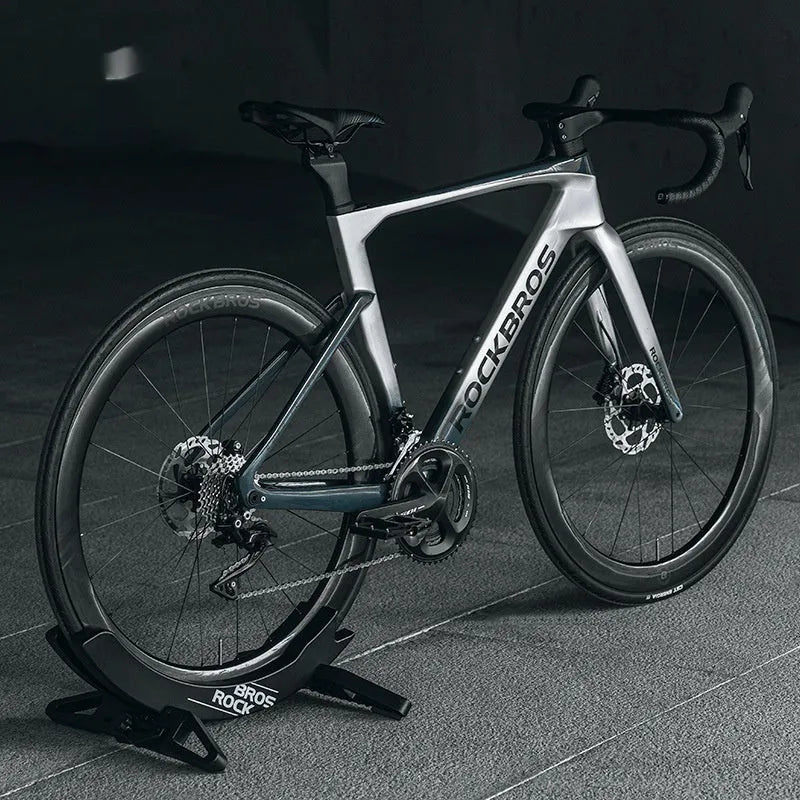 Black ABS plastic wall-mounted bicycle parking rack holder for road and mountain bikes.