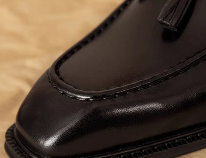 Men's black genuine leather slip-on loafers with polished finish and rubber sole