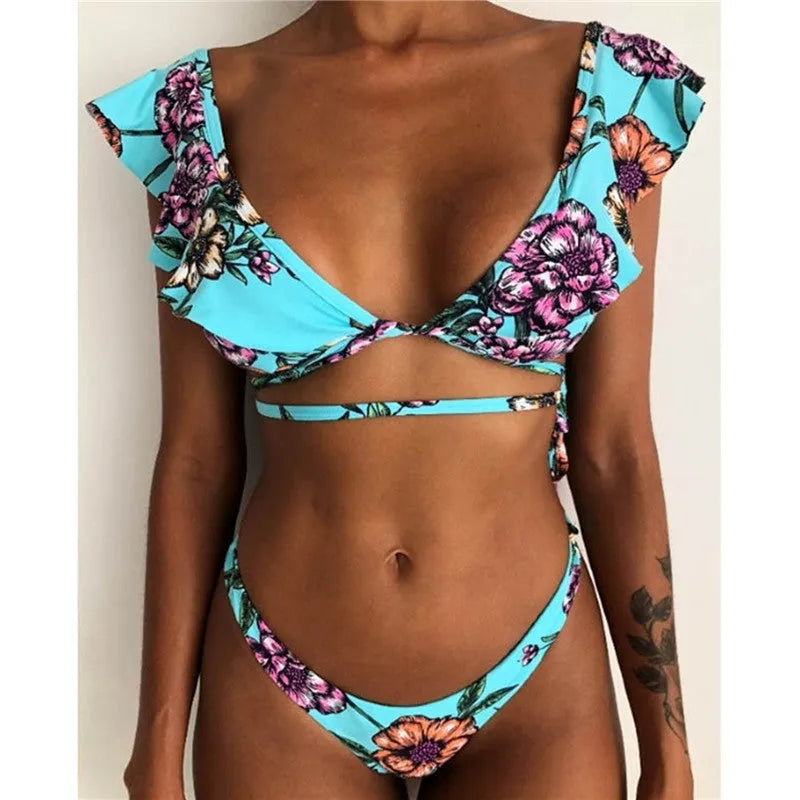 Yellow floral print split bikini swimsuit set with top and pants on a mannequin.