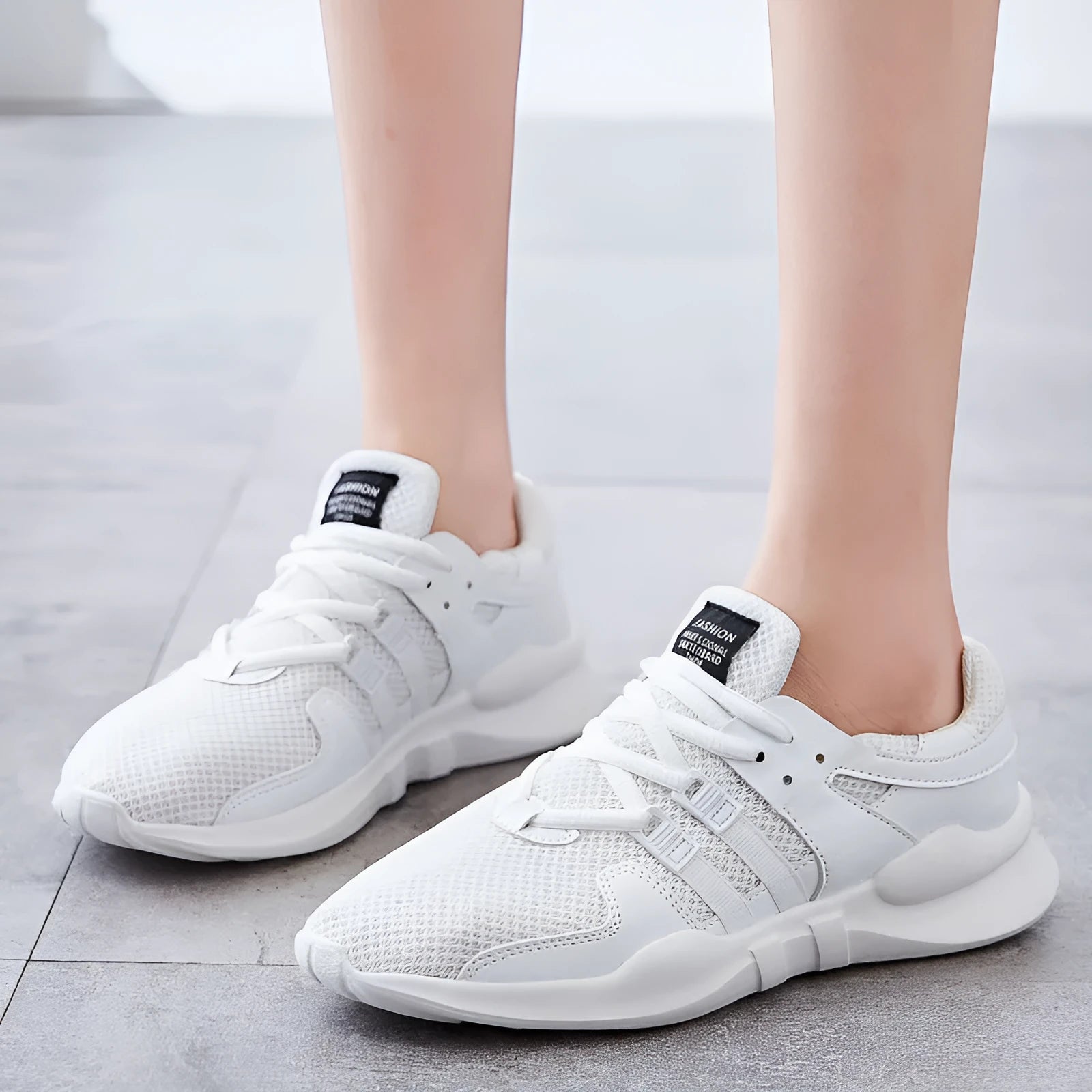 Low-top casual sneaker in mesh with hollow-out design and round toe.