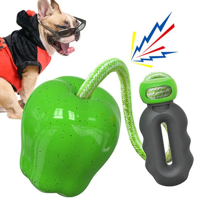 Green squeaky apple-shaped dog toy with treat-dispensing function, approximately 10-12cm diameter