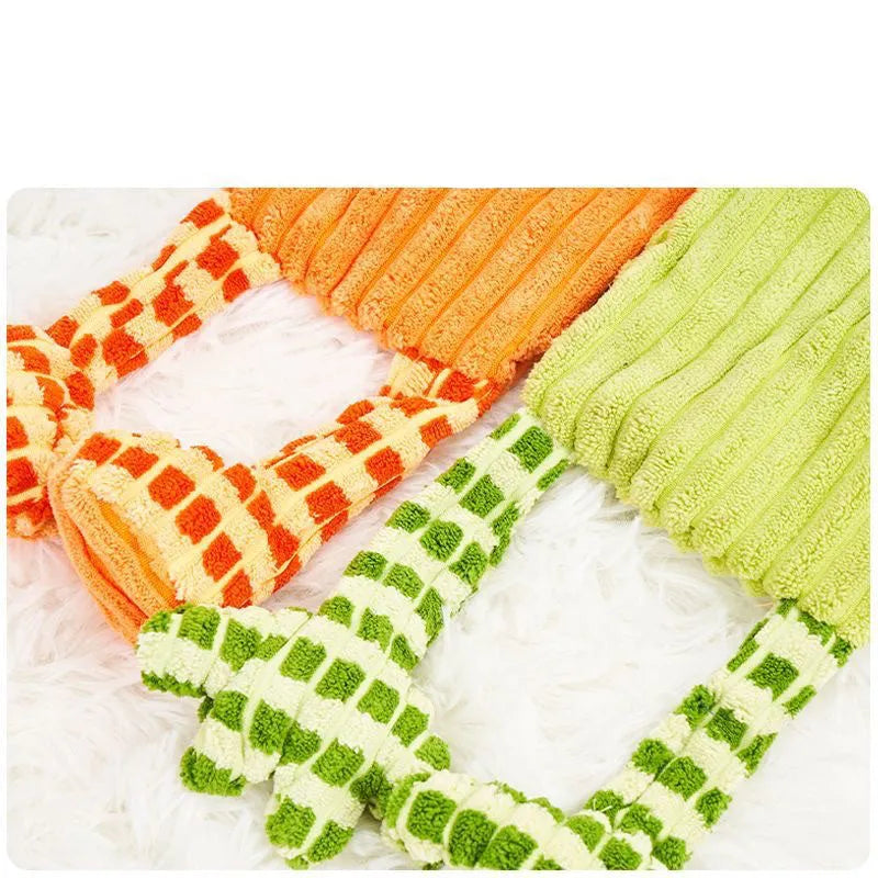 Green and orange plush dog toy with a squeaker for aggressive chewers.