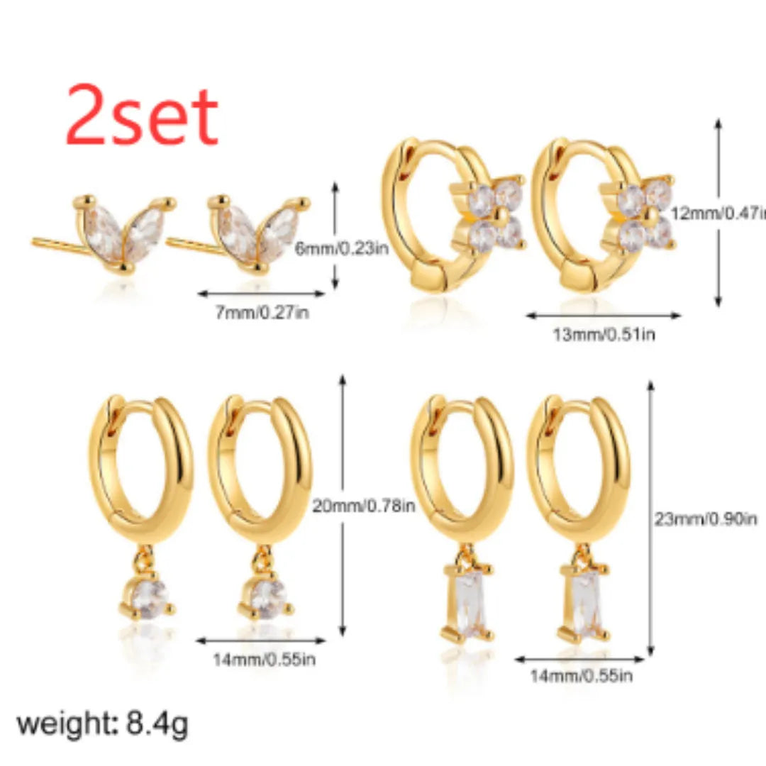 A set of geometric and star-shaped copper earrings with zircon accents in gold or silver plating.