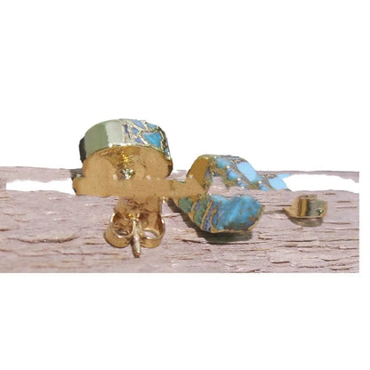 Handmade natural stone bohemian style stud earrings with an irregular organic shape on a grey background.