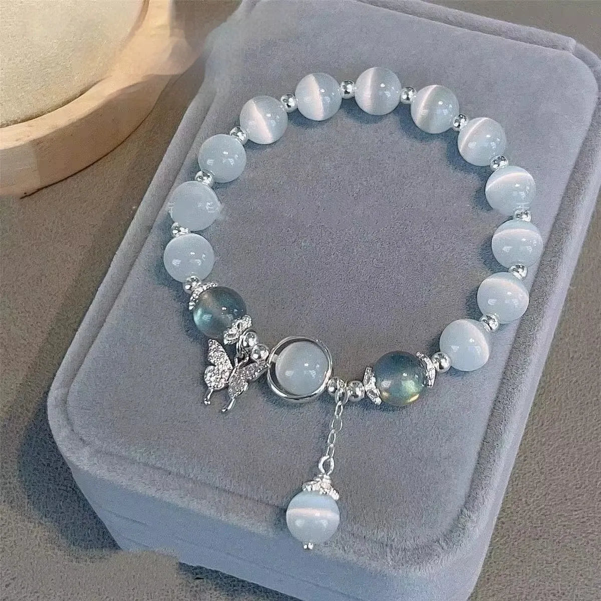 Handmade glass butterfly bracelet with drop-shaped beads in moonlight grey colour variation