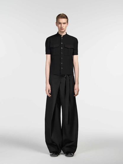 Black straight-leg trousers with a single front pleat and adjustable mid-waist on a hanger.