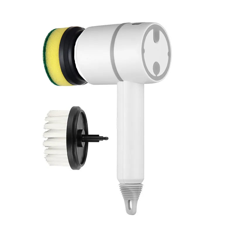 Green electric cleaning brush with scouring pad and brush heads on a kitchen worktop.