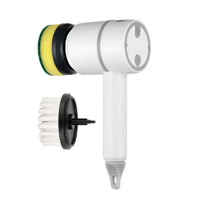 Green electric cleaning brush with scouring pad and brush heads on a kitchen worktop.