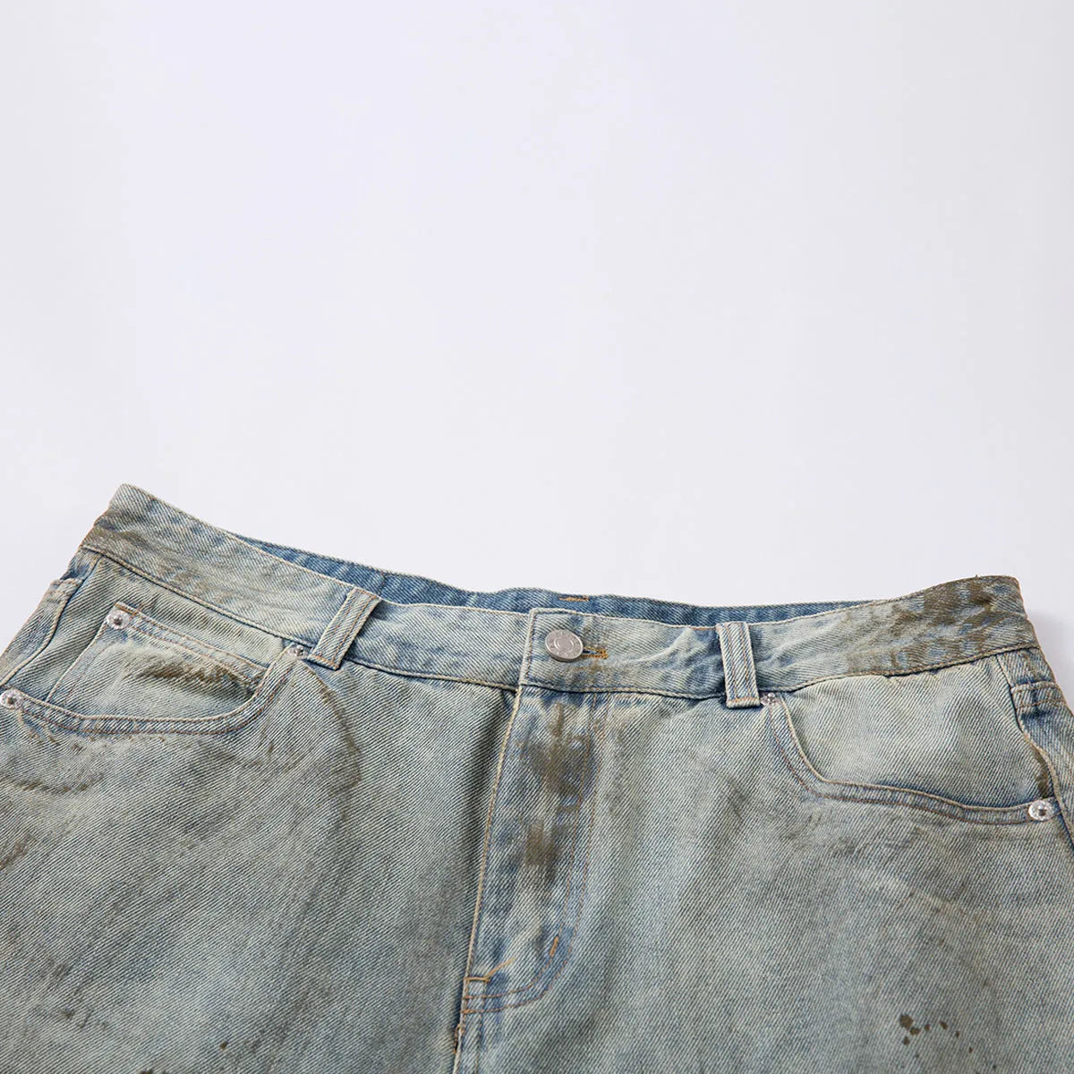 Blue denim cropped middle pants with straight-leg style and zipper fly closure on a street fashion background