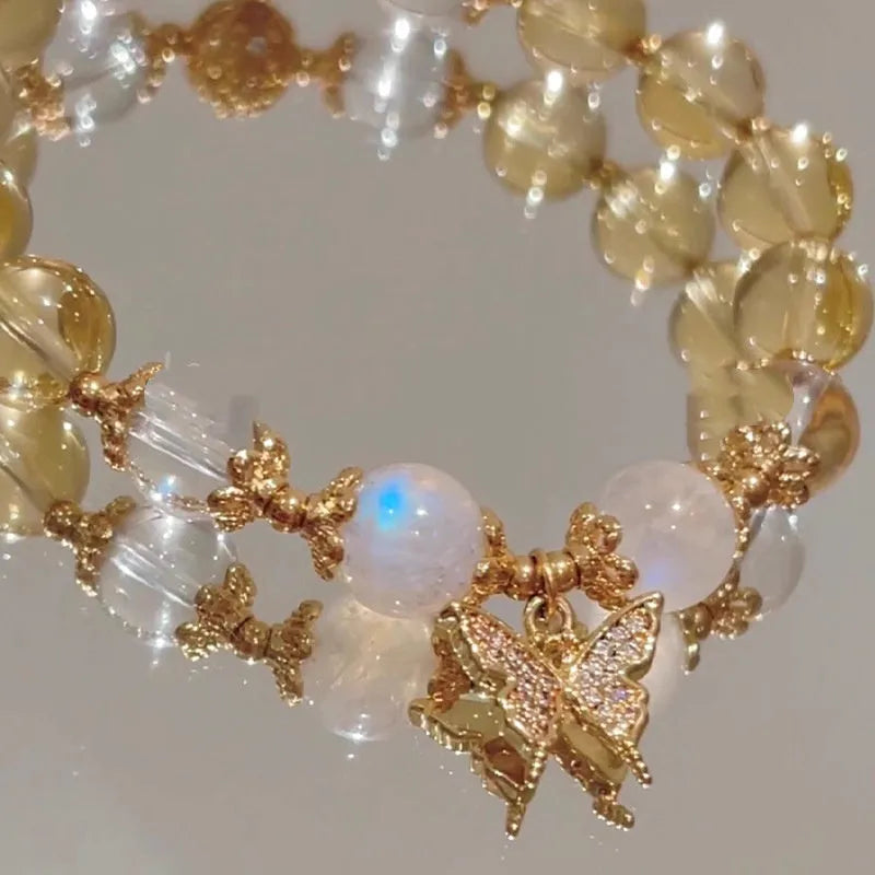 Chinese style white crystal beaded bracelet with citrine butterfly charm on adjustable string.