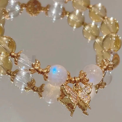 Chinese style white crystal beaded bracelet with citrine butterfly charm on adjustable string.