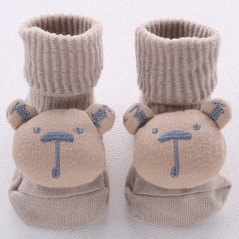 Cotton baby floor socks in assorted colours and patterns including bows, stars, and animal designs.