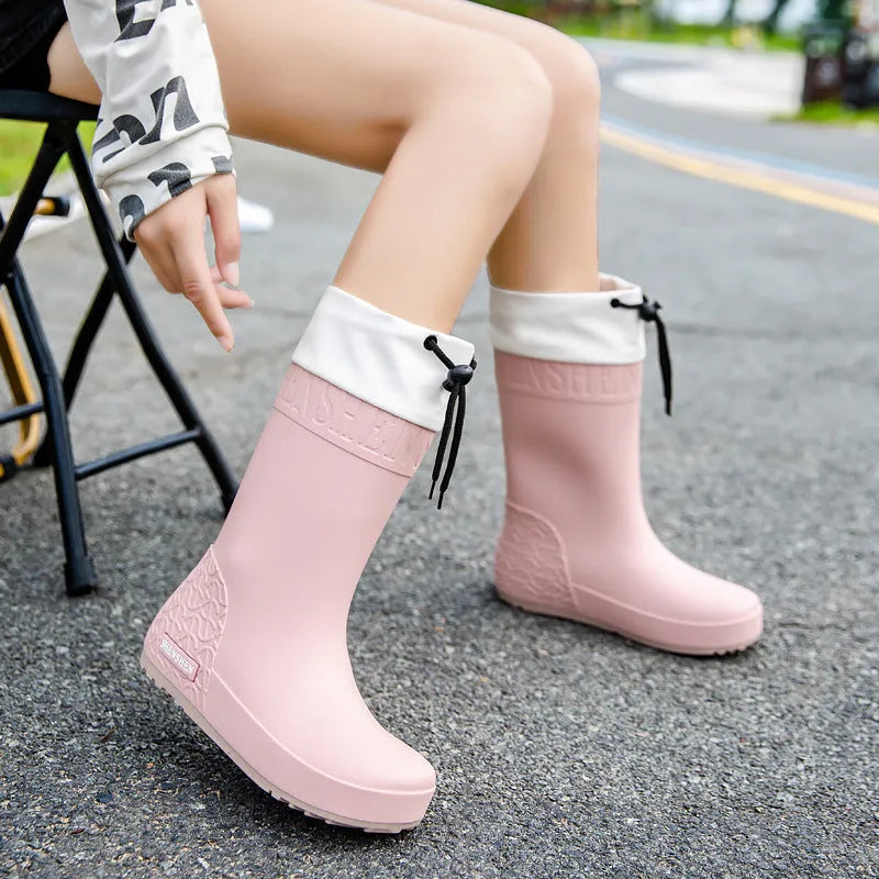 Women's solid colour PVC rain boots with non-slip soles in apricot, black, brown, or pink