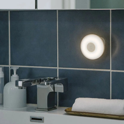 White modern bedside table lamp with human body sensor and Bluetooth connectivity, dimensions 94mm by 94mm by 71mm.