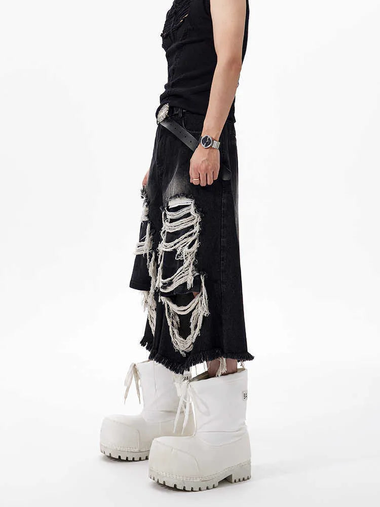 Black cropped wide-leg jeans with a mid-high waist, ripped patch detail, and a loose fit on a model.