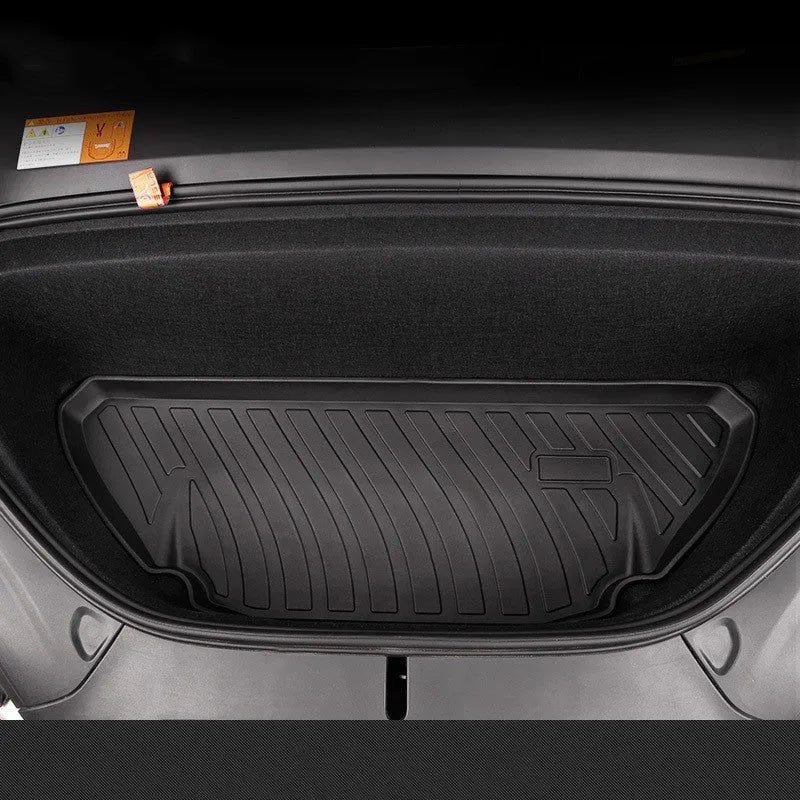 Black TPE rubber floor mats for Tesla Model 3, showing deep grooves and raised edges on driver's side.