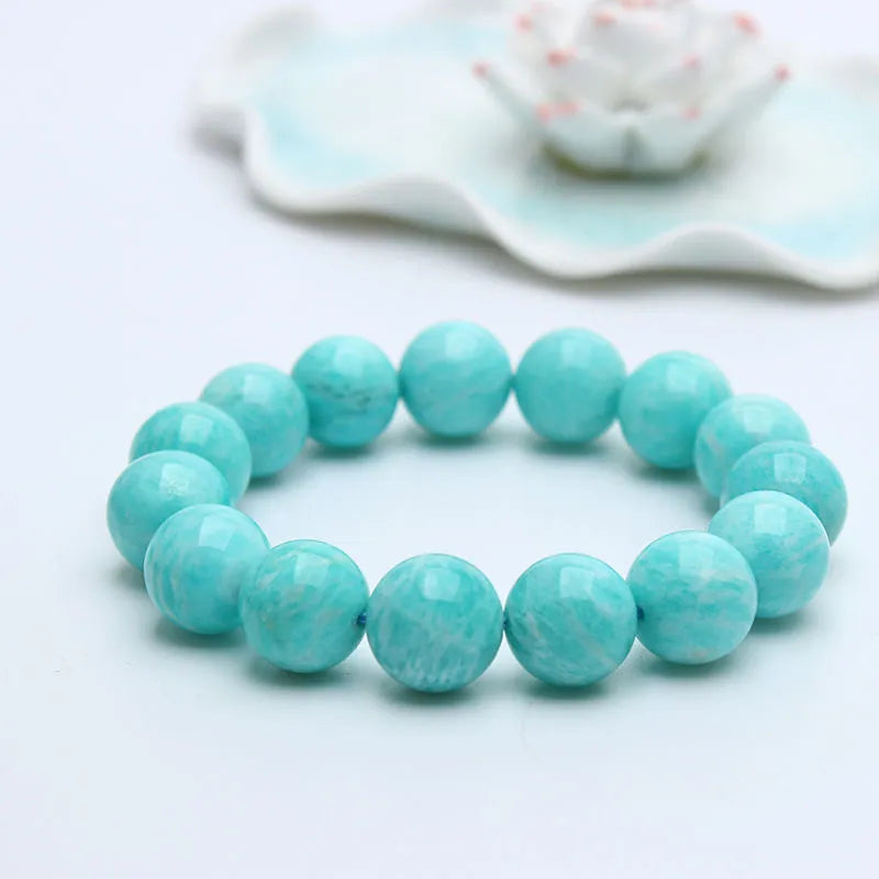 Natural teal blue amazonite gemstone bead bracelet on a white background, showing stretch elastic cord.