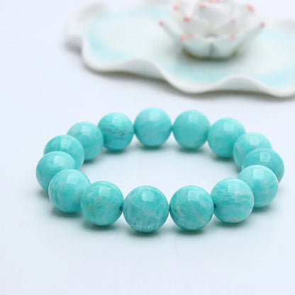 Natural teal blue amazonite gemstone bead bracelet on a white background, showing stretch elastic cord.