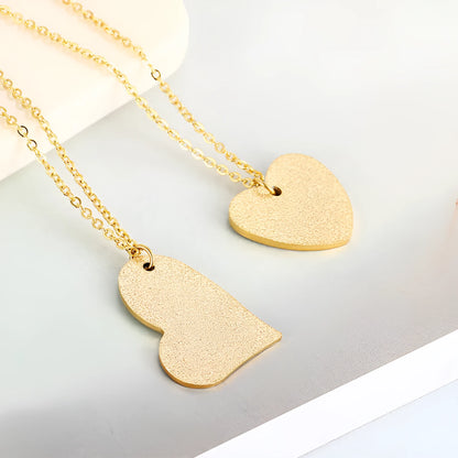 Women's titanium steel necklace with a simple geometric heart-shaped pendant.