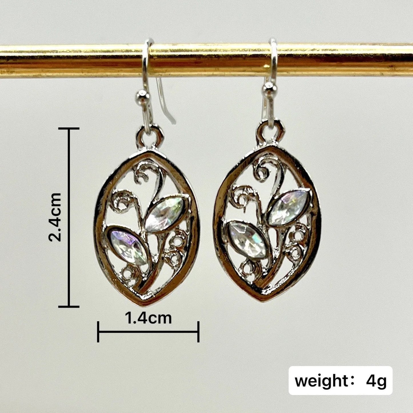 Silver leaf-shaped earrings with a central colourful moonstone on a white background.