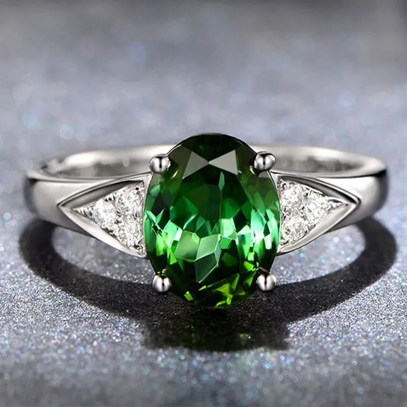 Women's zircon ring with natural blue or red zircon inlay, showing heart, water drop, or bell pattern on court style band.