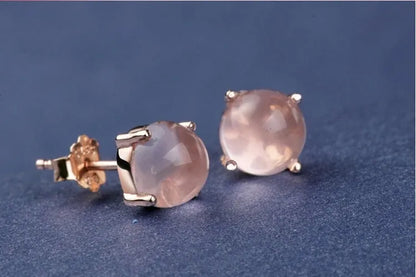 Women's drop-shaped stud earrings with synthetic rose quartz inlay and rose gold plating.