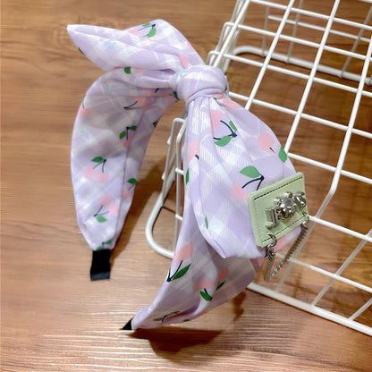 Geometric fringed headband in cloth material with manual craftsmanship details