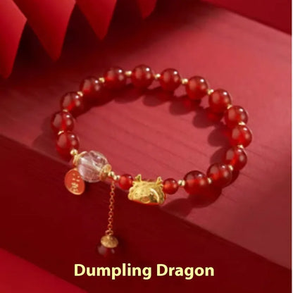 Women's Chinese style bracelet with Hetian jade, red agate beads, and a dragon design on gold and silver.