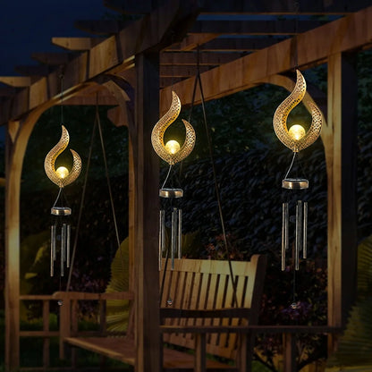 Solar wrought iron wind chime lamp with hollow flame design for garden lighting
