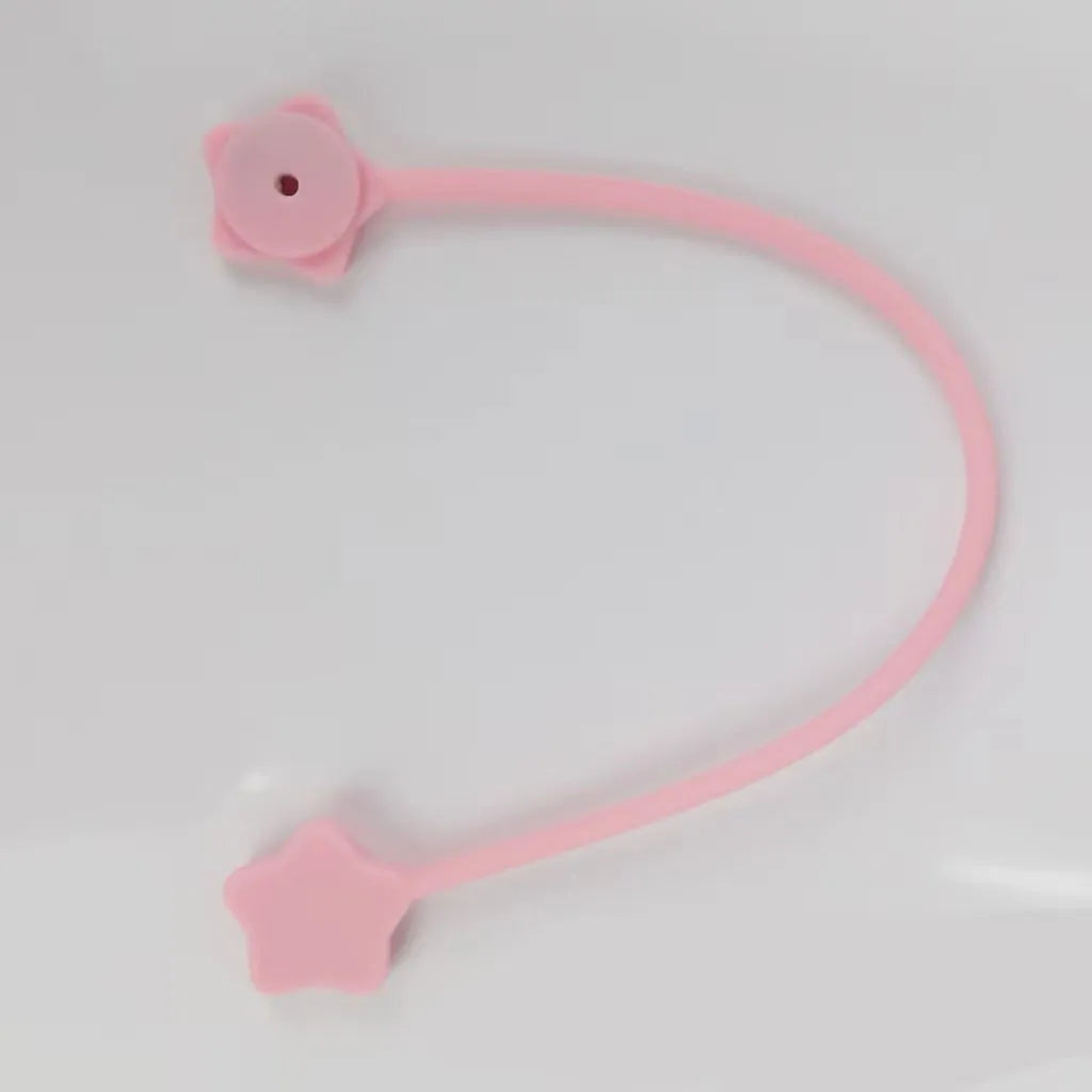 Compact purple silicone cable winder with magnet, shown coiling a white headphone cable.