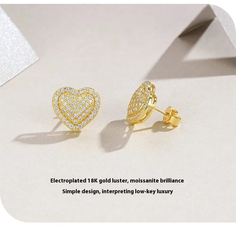 Golden S925 silver stud earrings with a heart-shaped moissanite stone.