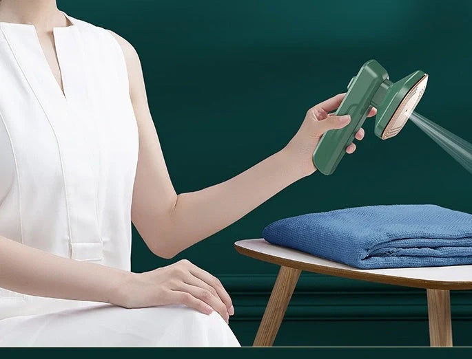 Compact green handheld garment steamer for quick ironing and cleaning