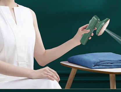 Compact green handheld garment steamer for quick ironing and cleaning