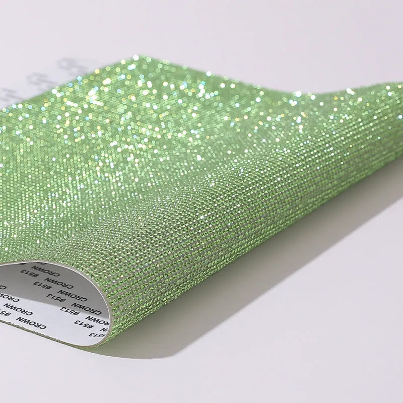 Rhinestone sticker net on backing sheet for hot drilling application to fabrics in multiple colour options