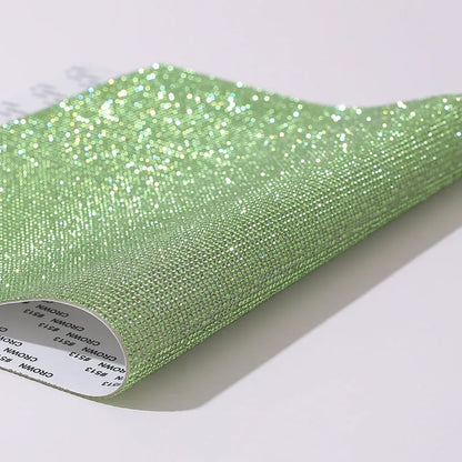 Rhinestone sticker net on backing sheet for hot drilling application to fabrics in multiple colour options