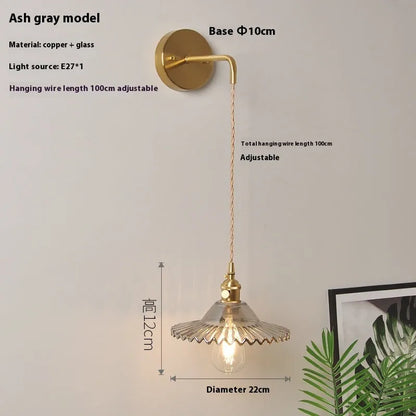 Retro brass lotus wall lamp with copper body and glass shade in various colours, mounted on a wall