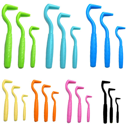 Set of three coloured tick hook removal tools for dogs on a white background.