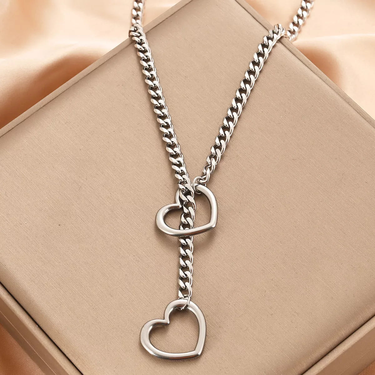 Stainless steel lariat heart necklace with heavy ring and Cuban chain in multiple finishes