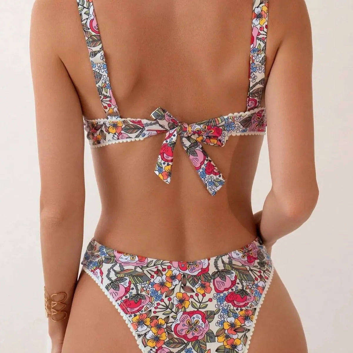 Women's floral print bikini with high waist briefs and adjustable ties.