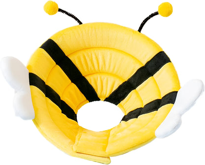 Soft fabric cat cone collar with cute bee design and Velcro closure on a table