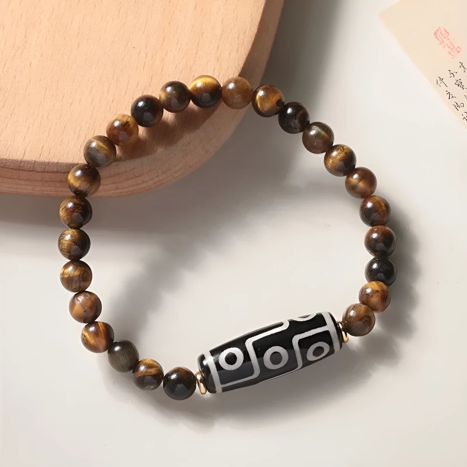 Single-circle beaded Buddha bracelet with tigereye Dzi stone, showing bead size options.