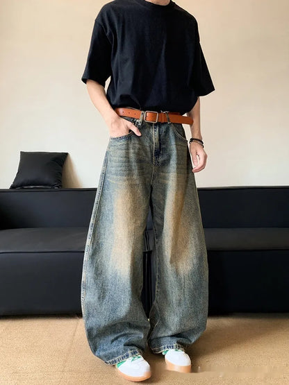 Man wearing retro blue distressed slim-fit jeans with a wide-leg cut.