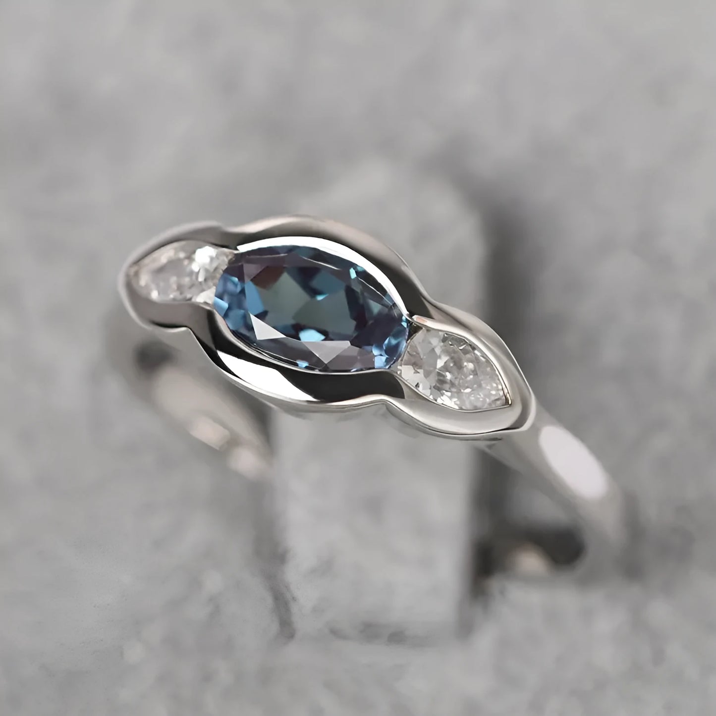 Women's geometric ellipse copper ring with inlaid zircon in white gold colour, showing distinctive non-circular shape