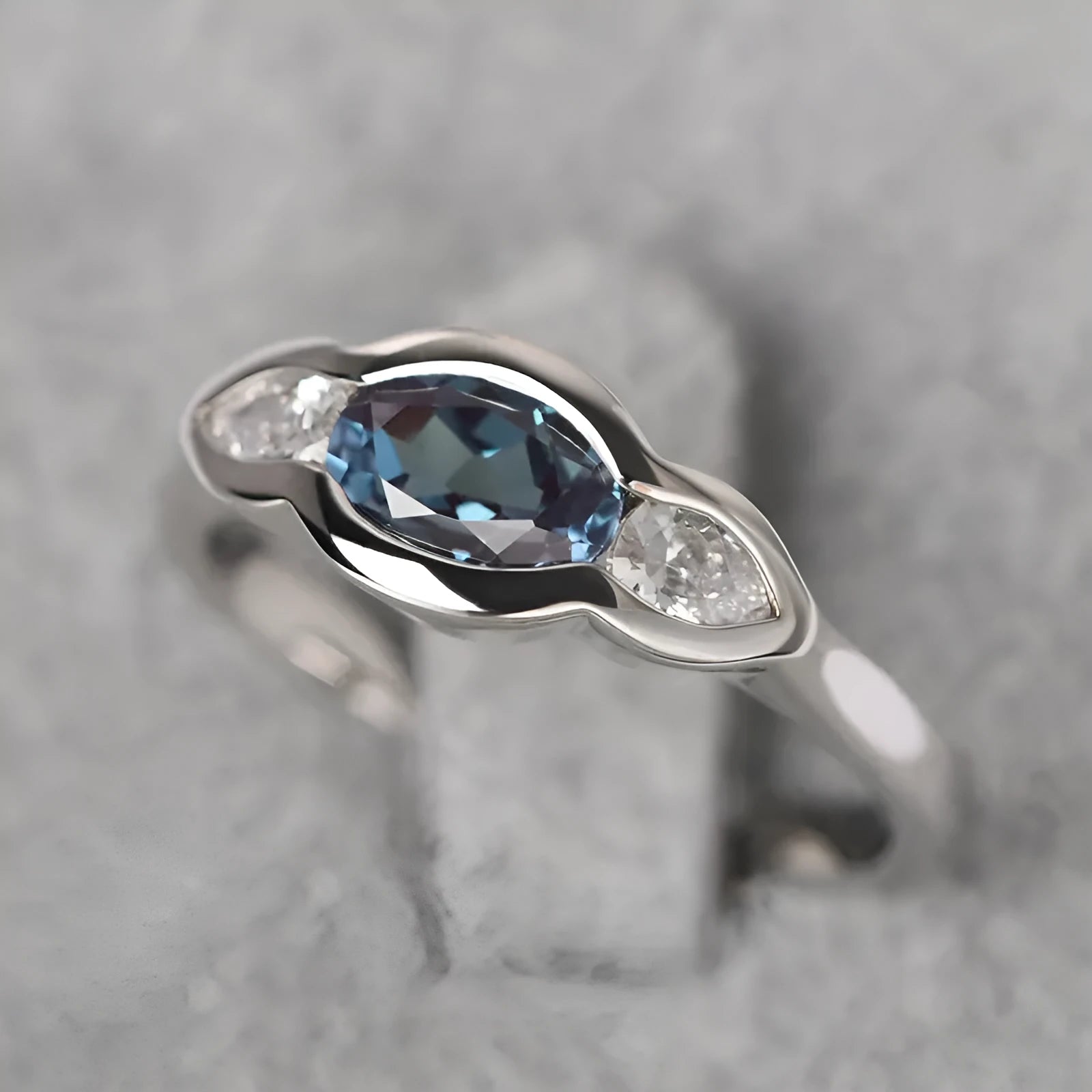 Women's geometric ellipse copper ring with inlaid zircon in white gold colour, showing distinctive non-circular shape