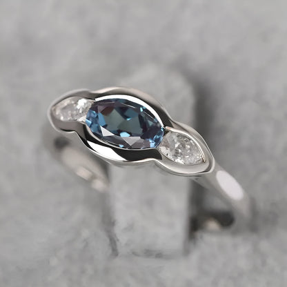 Women's geometric ellipse copper ring with inlaid zircon in white gold colour, showing distinctive non-circular shape
